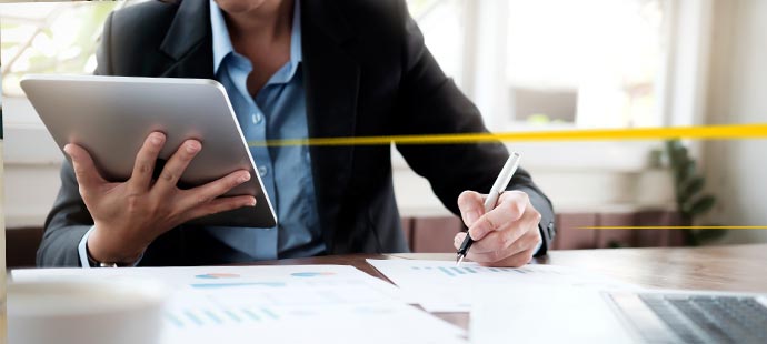 LGI executive with tablet at desk