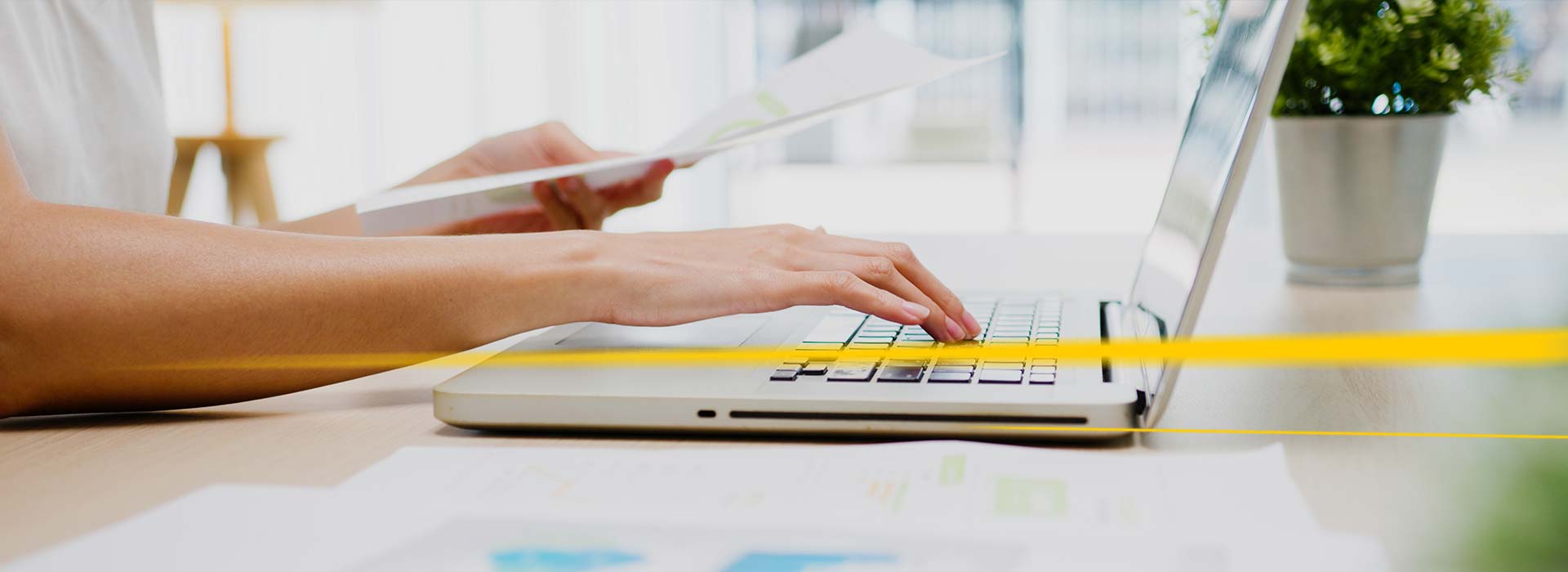 Person on laptop with documents LGI